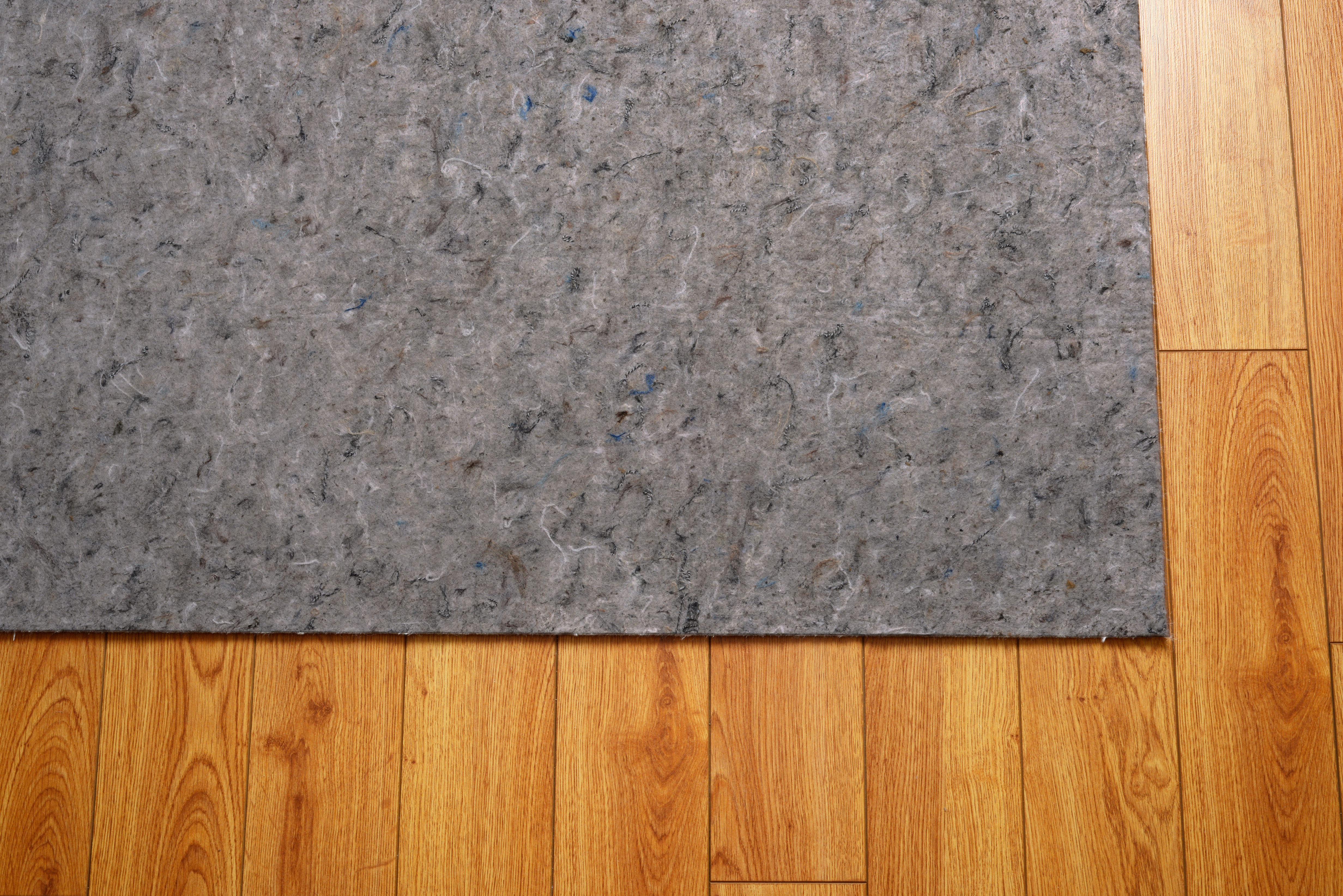 Area rug felt under pad on hardwood floor | Corvin's Floors & Cabinets